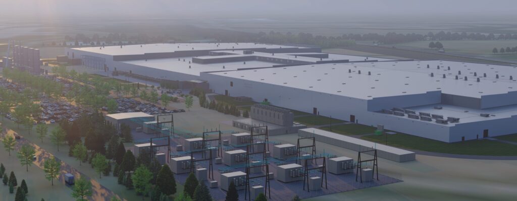 Aerial view of a large industrial facility with a white roof, surrounded by greenery, parking lots, and electrical infrastructure in the foreground, under a hazy sky.