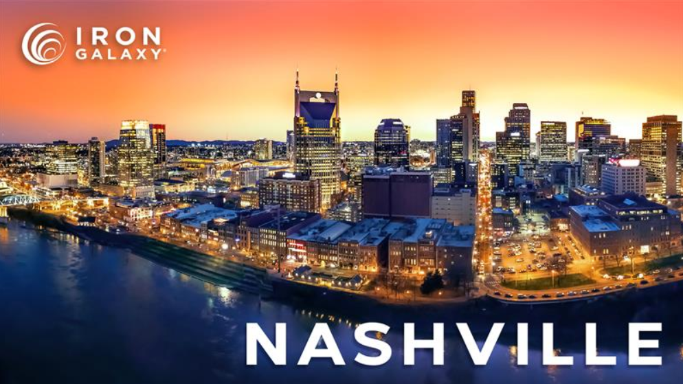 A vibrant sunset view of downtown Nashville’s skyline reflected in the river, with the Iron Galaxy logo and text “NASHVILLE” overlayed on the image.
