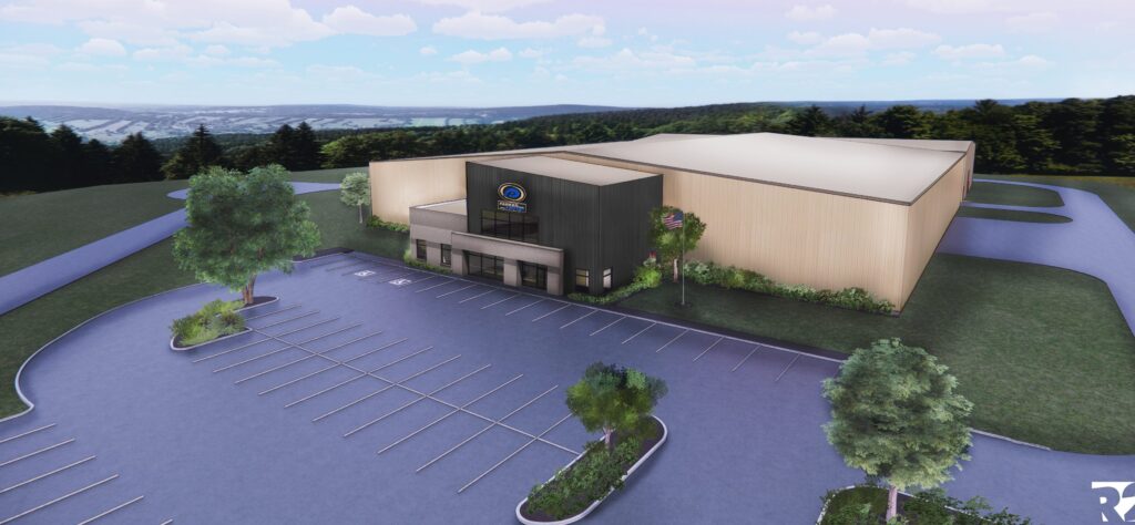 A digital rendering shows a modern, box-shaped building with a large entrance and minimal windows, surrounded by greenery and an empty parking lot under a partly cloudy sky.