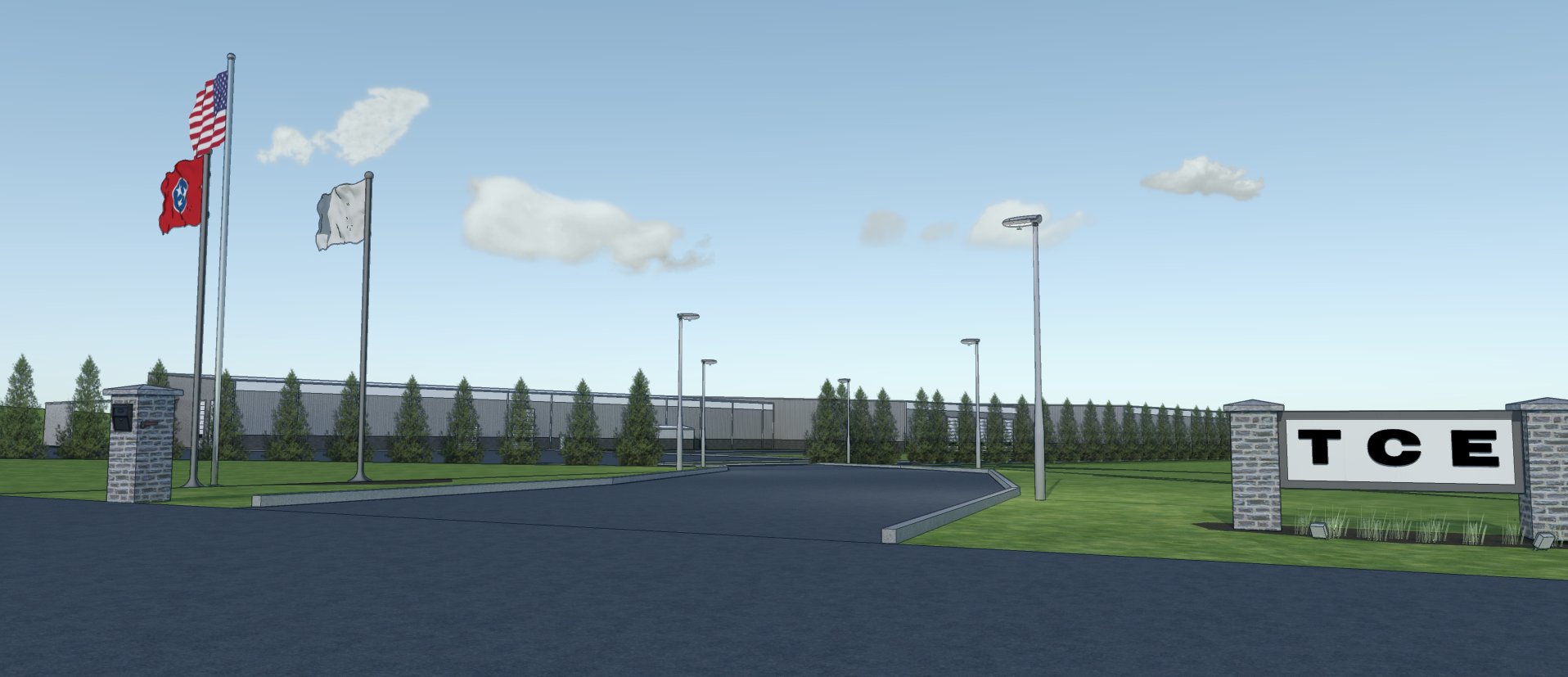 A wide driveway leads to a gated facility with a "TCE" sign, lined by streetlights and trees. Three flags, including the U.S. and Tennessee flags, fly near the entrance under a blue sky with scattered clouds.