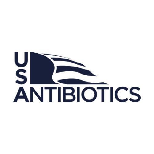 Logo of US Antibiotics with stylized dark blue text. The "US" appears vertically, and an abstract US flag design flows horizontally above the word "ANTIBIOTICS" on a white background.